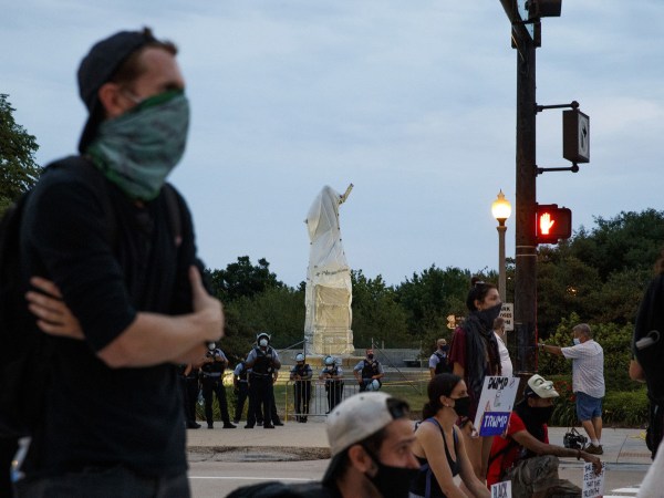 Activists stand at South Columbus Drive and East Roosevelt Road near the Christopher Columbus statue in Chicago on July 20, 2020. (Armando L. Sanchez/Chicago Tribune/TNS)