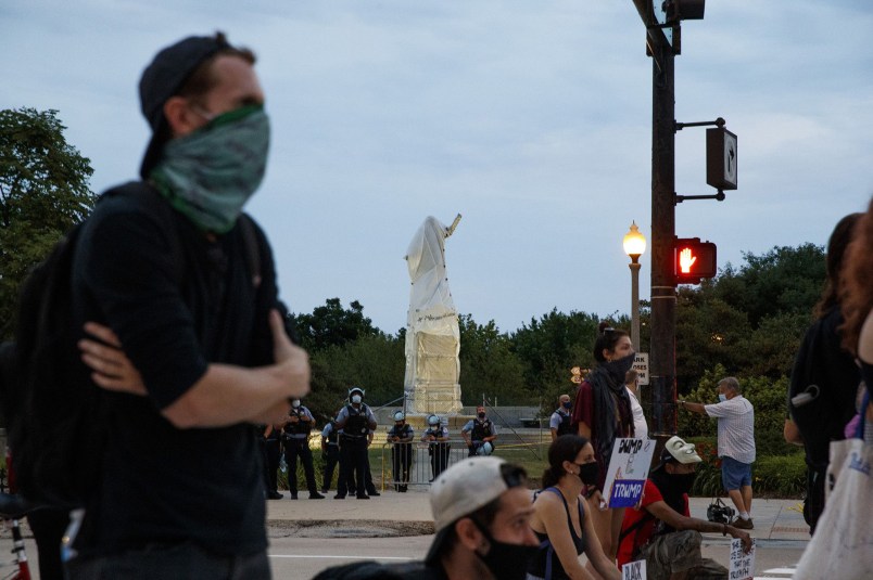 Activists stand at South Columbus Drive and East Roosevelt Road near the Christopher Columbus statue in Chicago on July 20, 2020. (Armando L. Sanchez/Chicago Tribune/TNS)
