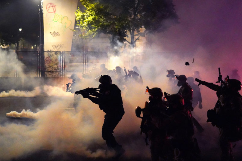 PORTLAND, OR - JULY 24: Federal officers deploy tear gas and less-lethal munitions while dispersing a crowd of about a thousand protesters in front of the Mark O. Hatfield U.S. Courthouse on Thursday, July 24, 2020 in Portland, Oregon.  Protesters continued to clash with federal officers Friday morning as President Trump announced plans to deploy similar federal forces to other U.S. cities. (Photo by Nathan Howard/Getty Images)
