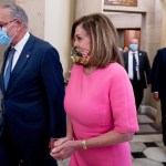 Senate Minority Leader Sen. Chuck Schumer of N.Y., left, and House Speaker Nancy Pelosi of Calif., right, walk out of a meeting with Treasury Secretary Steven Mnuchin and White House Chief of Staff Mark Meadows as they continue to negotiate a coronavirus relief package on Capitol Hill in Washington, Friday, Aug. 7, 2020. (AP Photo/Andrew Harnik)