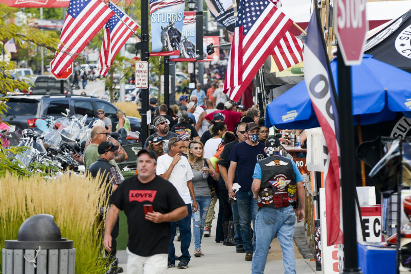 STURGIS, SD - AUGUST 06: People walk along Main Street a day before the start of the Sturgis Motorcycle Rally on August 6, 2020 in Sturgis, South Dakota. While the rally usually attracts around 500,000 people, officials estimate that more than 250,000 people may still show up to this year's festival despite the coronavirus pandemic. (Photo by Michael Ciaglo/Getty Images)