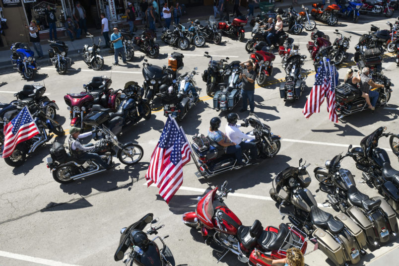STURGIS, SD - AUGUST 07: Motorcyclists ride down Main Street during the 80th Annual Sturgis Motorcycle Rally on August 7, 2020 in Sturgis, South Dakota. While the rally usually attracts around 500,000 people, officials estimate that more than 250,000 people may still show up to this year's festival despite the coronavirus pandemic. (Photo by Michael Ciaglo/Getty Images)