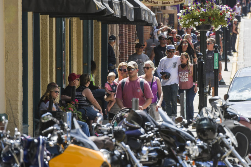 DEADWOOD, SD - AUGUST 08: People walk through downtown Deadwood, South Dakota during the 80th Annual Sturgis Motorcycle Rally on August 8, 2020. While the rally usually attracts around 500,000 people, officials estimate that more than 250,000 people may still show up to this year's festival despite the coronavirus pandemic. (Photo by Michael Ciaglo/Getty Images)