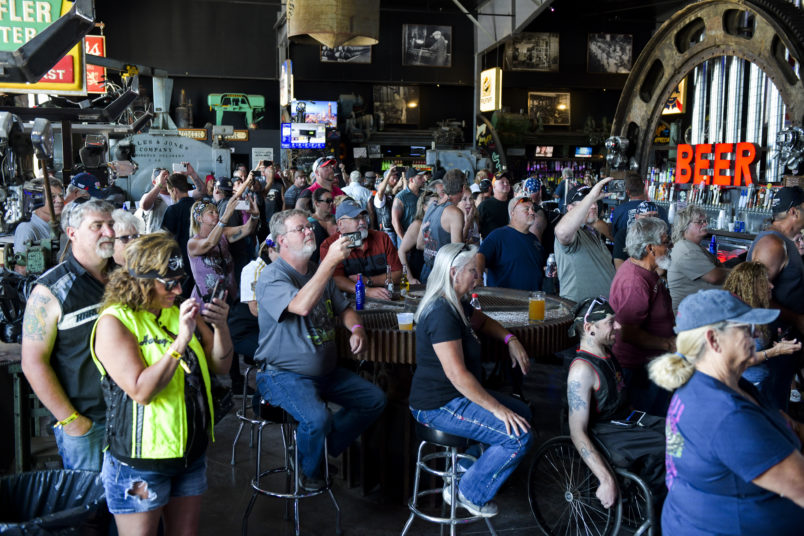 STURGIS, SD - AUGUST 09: People watch a concert at the Full Throttle Saloon during the 80th Annual Sturgis Motorcycle Rally in Sturgis, South Dakota on August 9, 2020. While the rally usually attracts around 500,000 people, officials estimate that more than 250,000 people may still show up to this year's festival despite the coronavirus pandemic. (Photo by Michael Ciaglo/Getty Images)