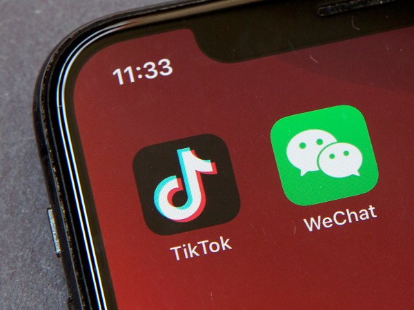 Icons for the smartphone apps TikTok and WeChat are seen on a smartphone screen in Beijing, Friday, Aug. 7, 2020. President Donald Trump has ordered a sweeping but unspecified ban on dealings with the Chinese owners of the consumer apps TikTok and WeChat, although it remains unclear if he has the legal authority to actually ban the apps from the U.S. (AP Photo/Mark Schiefelbein)