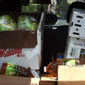 Boxes of food aid from the Second Harvest Food Bank of Central Florida are seen in the back of a car at a drive through food distribution event for the needy at Church in the Son on August 7, 2020 in Orlando, Florida. Food Banks in the Orlando area are bracing for a spike in demand as the $600 weekly enhanced unemployment benefits that the jobless have been receiving from the federal government expired at the end of July.  (Photo by Paul Hennessy/NurPhoto)
