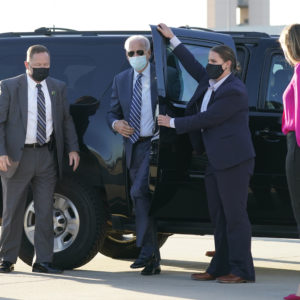 Democratic presidential candidate former Vice President Joe Biden steps out to board his campaign plane at Raleigh-Durham International Airport in Morrisville, N.C., Sunday, Oct. 18, 2020, en route to Wilmington, Del., as granddaughter Finnegan Biden looks on, right.  AP Photo/Carolyn Kaster)