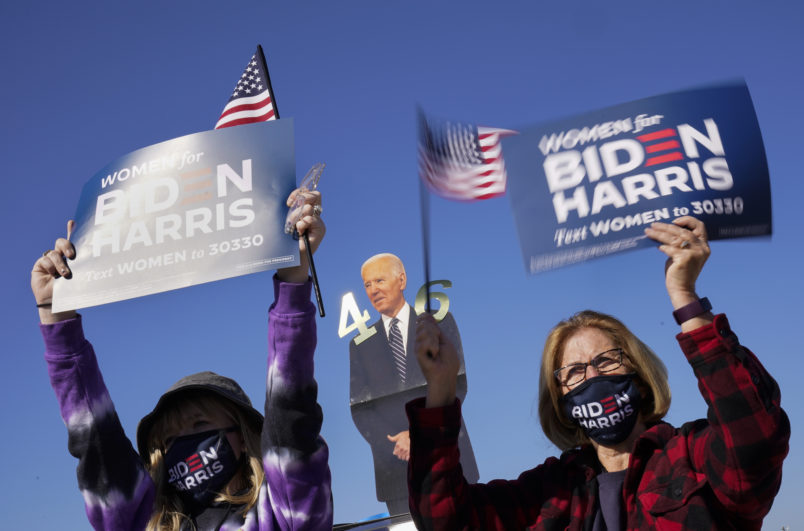 Supporters listen as Democratic presidential candidate former Vice President Joe Biden speaks at a rally at the Iowa State Fairgrounds in Des Moines, Iowa, Friday, Oct. 30, 2020. (AP Photo/Andrew Harnik)