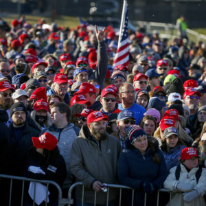 People wait outside the airport before a campaign rally with President Donald Trump Friday, Oct. 30, 2020, in Rochester, Minn. (AP Photo/Bruce Kluckhohn)