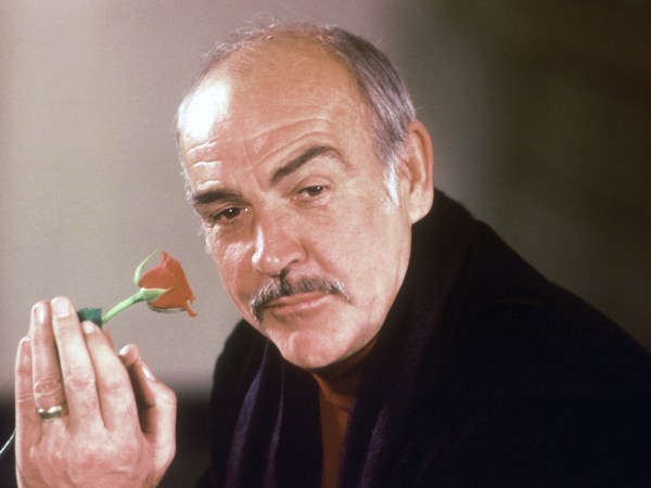 Actor Sean Connery holds a rose in his hand as he talks about his new movie "The Name of the Rose" at a news conference in London, England, Jan. 23, 1987.  (AP Photo/Gerald Penny)