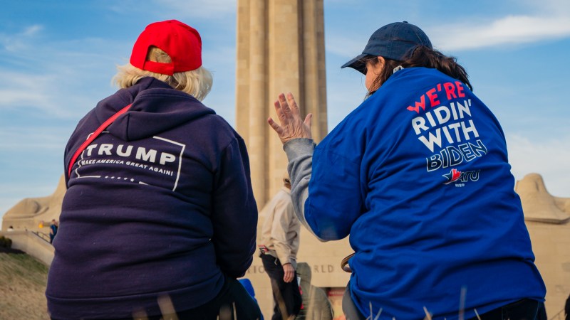 KANSAS CITY, MO - MARCH 07: A President Donald Trump and a former Vice President Joe Biden supporter converse before the Joe Biden Campaign Rally at the National World War I Museum and Memorial on March 7, 2020 in Kansas City, Missouri. (Photo by Kyle Rivas/Getty Images)