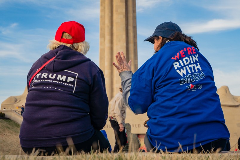 KANSAS CITY, MO - MARCH 07: A President Donald Trump and a former Vice President Joe Biden supporter converse before the Joe Biden Campaign Rally at the National World War I Museum and Memorial on March 7, 2020 in Kansas City, Missouri. (Photo by Kyle Rivas/Getty Images)