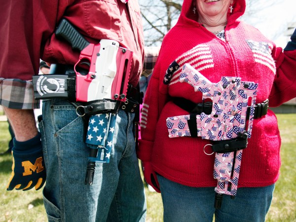 ROMULUS, MI - APRIL 24: Chris (right) and Marty Welch of Cadillac, Michigan, carry decorated Olympic Arms .223 pistols at a rally for supporters of Michigan's Open Carry law  April 27, 2014 in Romulus, Michigan. The march was held to attempt to demonstrate to the general public what the typical open carrier is like. (Photo by Bill Pugliano/Getty Images)