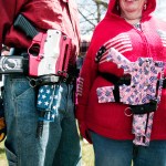 ROMULUS, MI - APRIL 24: Chris (right) and Marty Welch of Cadillac, Michigan, carry decorated Olympic Arms .223 pistols at a rally for supporters of Michigan's Open Carry law  April 27, 2014 in Romulus, Michigan. The march was held to attempt to demonstrate to the general public what the typical open carrier is like. (Photo by Bill Pugliano/Getty Images)