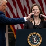 President Donald Trump adjusts the microphone after he announced Judge Amy Coney Barrett as his nominee to the Supreme Court, in the Rose Garden at the White House, Saturday, Sept. 26, 2020, in Washington. (AP Photo/Alex Brandon)