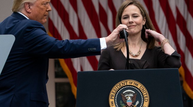 President Donald Trump adjusts the microphone after he announced Judge Amy Coney Barrett as his nominee to the Supreme Court, in the Rose Garden at the White House, Saturday, Sept. 26, 2020, in Washington. (AP Photo/Alex Brandon)