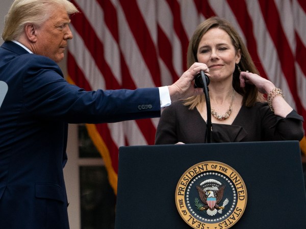 President Donald Trump adjusts the microphone after he announced Judge Amy Coney Barrett as his nominee to the Supreme Court, in the Rose Garden at the White House, Saturday, Sept. 26, 2020, in Washington. (AP Photo/Alex Brandon)