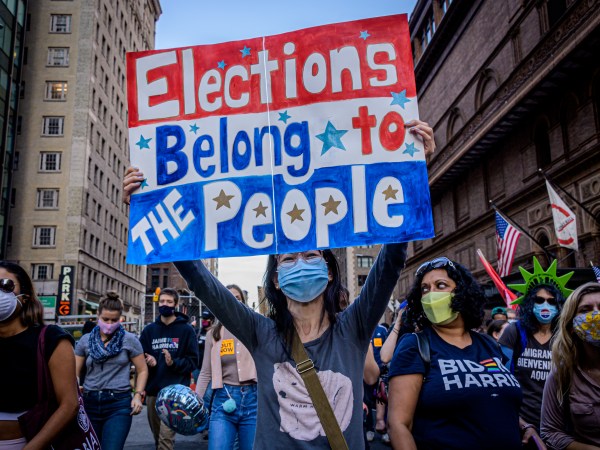 MANHATTAN, NEW YORK, UNITED STATES - 2020/11/07: A participant holding a sign at the celebratory march. Thousands of New Yorkers joined members of the Protect the Results: New York City Coalition, a group formed by over 90 local community organizations at Columbus Circle for the March to Protect The Results, taking the streets of Manhattan to celebrate the Biden-Harris ticket victory after winning the majority of the Electoral College votes. (Photo by Erik McGregor/LightRocket via Getty Images)
