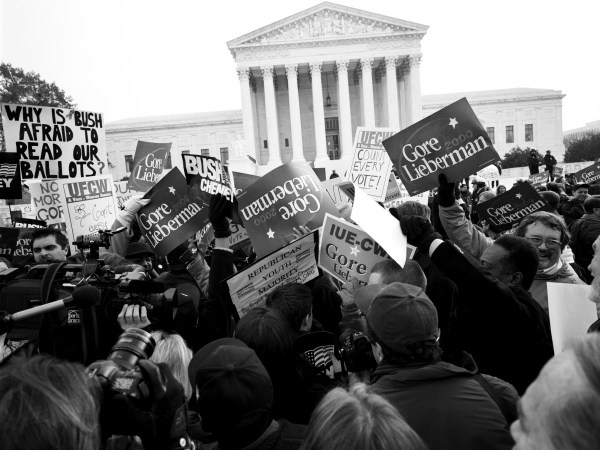 WASHINGTON DC - DECEMBER 11: Protesters outside the Supreme Court on the eve of the decision on Gore v Bush that will determine the outcome of the Presidential Election on December 11, 2000 in Washington DC. (Photo by David Hume Kennerly/Getty Images)