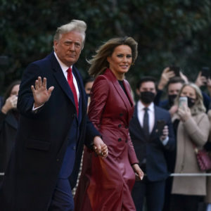 President Donald Trump and first lady Melania Trump walk on the South Lawn of the White House in Washington, Saturday, Dec. 5, 2020, before boarding Marine One for a short trip to Andrews Air Force Base, Md. Trump is en route to Georgia for a rally for U.S. Senate candidates David Perdue and Kelly Loeffler. (AP Photo/Patrick Semansky)