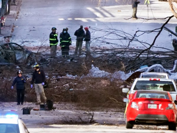 Investigators work at the scene of an explosion Saturday, Dec. 26, 2020, in Nashville, Tenn. The explosion that shook the largely deserted streets of downtown Nashville early Christmas morning shattered windows, damaged buildings and wounded three people. Authorities said they believed the blast was intentional. (AP Photo/Mark Humphrey)