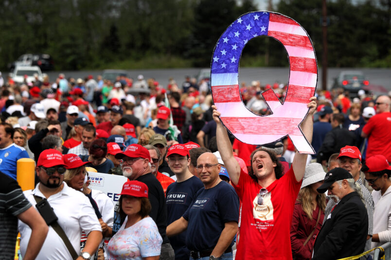 WILKES BARRE, PA - AUGUST 02: David Reinert holds up a large "Q" sign while waiting in line on August 2, 2018 at the Mohegan Sun Arena at Casey Plaza in Wilkes Barre, Pennsylvania to see President Donald J. Trump at his rally. "Q" is a conspiracy theory group that has been seen at recent rallies.    (Photo by Rick Loomis/Getty Images)
