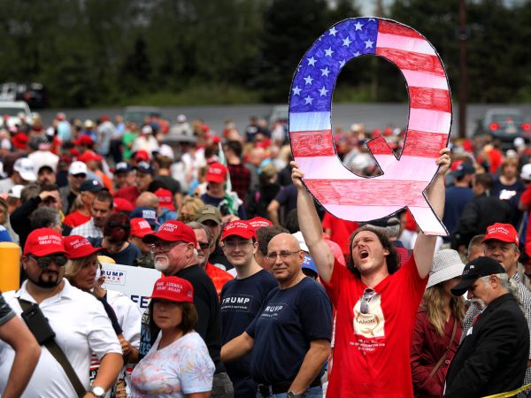 WILKES BARRE, PA - AUGUST 02: David Reinert holds up a large "Q" sign while waiting in line on August 2, 2018 at the Mohegan Sun Arena at Casey Plaza in Wilkes Barre, Pennsylvania to see President Donald J. Trump at his rally. "Q" is a conspiracy theory group that has been seen at recent rallies.    (Photo by Rick Loomis/Getty Images)