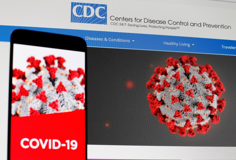 UKRAINE - 2020/04/29: In this photo illustration the Centers of Disease Control and Prevention (CDC) web page displayed in internet on a pc screen and a coronavirus image on a mobile phone.The number of the COVID-19 coronavirus confirmed cases in the United States exceeded one million and exceeded three million in the world, according of COVID-19 Dashboard by the Center for Systems Science and Engineering (CSSE) at Johns Hopkins University (JHU). The World Health Organization declared the coronavirus a global pandemic on 11 March 2020. (Photo Illustration by Pavlo Gonchar/SOPA Images/LightRocket via Getty Images)