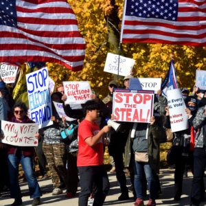 WILKES-BARRE, PENNSYLVANIA, UNITED STATES - 2020/11/06: Protesters holding placards, waving flags as they chant slogans during the demonstration.Over 100 protesters came out to demonstrate at the elections board after Joe Biden overtook President Trump in Pennsylvania during the vote count. Protesters argue that any vote received after November 3 should not be counted. (Photo by Aimee Dilger/SOPA Images/LightRocket via Getty Images)