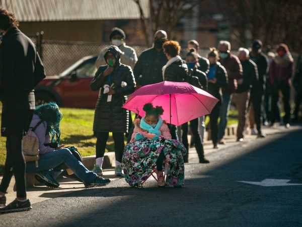ATLANTA, GA - DECEMBER 14: Voters wait in a long line to vote at the Buckhead library in Atlanta on the first day of In-person early voting for the Georgia Senate runoff election on Monday, Dec. 14, 2020 in Atlanta, GA. (Jason Armond / Los Angeles Times)