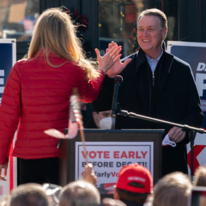 MILTON, GA - DECEMBER 21: Senators Kelly Loeffler and David Perdue high five each other as Perdue takes the stage to speak during a campaign event on December 21, 2020 in Milton, Georgia. The two Georgia U.S. Senate runoff elections on Jan. 5 will decide control of the Senate. (Photo by Elijah Nouvelage/Getty Images)