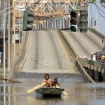 NEW ORLEANS - AUGUST 31:  Two men paddle in high water after Hurricane Katrina devastated the area August 31, 2005 in New Orleans, Louisiana. Devastation is widespread throughout the city with water approximately 12 feet high in some areas. Hundreds are feared dead and thousands were left homeless in Louisiana, Mississippi, Alabama and Florida by the storm.   (Photo by Mario Tama/Getty Images)