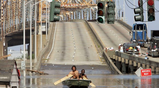 NEW ORLEANS - AUGUST 31:  Two men paddle in high water after Hurricane Katrina devastated the area August 31, 2005 in New Orleans, Louisiana. Devastation is widespread throughout the city with water approximately 12 feet high in some areas. Hundreds are feared dead and thousands were left homeless in Louisiana, Mississippi, Alabama and Florida by the storm.   (Photo by Mario Tama/Getty Images)