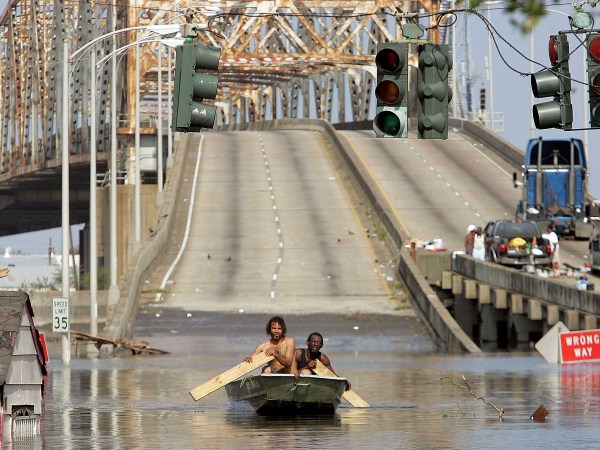 NEW ORLEANS - AUGUST 31:  Two men paddle in high water after Hurricane Katrina devastated the area August 31, 2005 in New Orleans, Louisiana. Devastation is widespread throughout the city with water approximately 12 feet high in some areas. Hundreds are feared dead and thousands were left homeless in Louisiana, Mississippi, Alabama and Florida by the storm.   (Photo by Mario Tama/Getty Images)