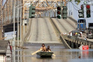 NEW ORLEANS - AUGUST 31:  Two men paddle in high water after Hurricane Katrina devastated the area August 31, 2005 in New Orleans, Louisiana. Devastation is widespread throughout the city with water approximately 12 feet high in some areas. Hundreds are feared dead and thousands were left homeless in Louisiana, Mississippi, Alabama and Florida by the storm.   (Photo by Mario Tama/Getty Images)