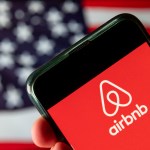 CHINA - 2020/08/15: In this photo illustration the American online marketplace and hospitality service Airbnb logo is seen on an Android mobile device with United States of America flag in the background. (Photo Illustration by Budrul Chukrut/SOPA Images/LightRocket via Getty Images)
