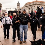 WASHINGTON, DC - JANUARY 05: US Park Police officers arrest a man on gun charges after officers spotted him carrying a concealed firearm during a pro-Trump rally at Freedom Plaza on January 5, 2021 in Washington, DC. Today's rally kicks off two days of pro-Trump events fueled by President Trump's continued claims of election fraud and a last ditch effort to overturn the results before Congress finalizes them on January 6. Gun laws in the District are extremely tight and further restrictions have been put in place within 100ft fo First Amendment events. (Photo by Samuel Corum/Getty Images)