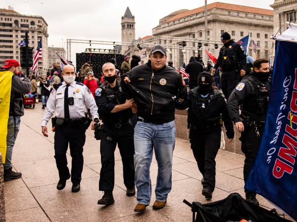WASHINGTON, DC - JANUARY 05: US Park Police officers arrest a man on gun charges after officers spotted him carrying a concealed firearm during a pro-Trump rally at Freedom Plaza on January 5, 2021 in Washington, DC. Today's rally kicks off two days of pro-Trump events fueled by President Trump's continued claims of election fraud and a last ditch effort to overturn the results before Congress finalizes them on January 6. Gun laws in the District are extremely tight and further restrictions have been put in place within 100ft fo First Amendment events. (Photo by Samuel Corum/Getty Images)