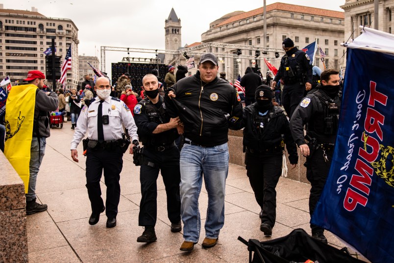 WASHINGTON, DC - JANUARY 05: US Park Police officers arrest a man on gun charges after officers spotted him carrying a concealed firearm during a pro-Trump rally at Freedom Plaza on January 5, 2021 in Washington, DC. Today's rally kicks off two days of pro-Trump events fueled by President Trump's continued claims of election fraud and a last ditch effort to overturn the results before Congress finalizes them on January 6. Gun laws in the District are extremely tight and further restrictions have been put in place within 100ft fo First Amendment events. (Photo by Samuel Corum/Getty Images)