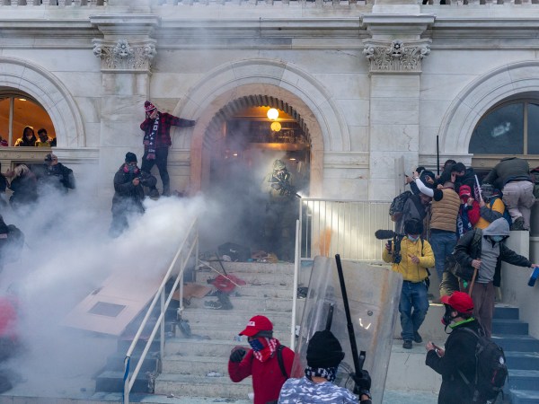 WASHINGTON DC, DISTRICT OF COLUMBIA, UNITED STATES - 2021/01/06: Police use tear gas around Capitol building where pro-Trump supporters riot and breached the Capitol. Rioters broke windows and breached the Capitol building in an attempt to overthrow the results of the 2020 election. Police used batons and tear gas grenades to eventually disperse the crowd. Rioters used metal bars and tear gas as well against the police. (Photo by Lev Radin/Pacific Press/LightRocket via Getty Images)