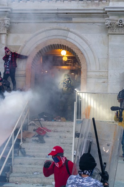 WASHINGTON DC, DISTRICT OF COLUMBIA, UNITED STATES - 2021/01/06: Police use tear gas around Capitol building where pro-Trump supporters riot and breached the Capitol. Rioters broke windows and breached the Capitol building in an attempt to overthrow the results of the 2020 election. Police used batons and tear gas grenades to eventually disperse the crowd. Rioters used metal bars and tear gas as well against the police. (Photo by Lev Radin/Pacific Press/LightRocket via Getty Images)
