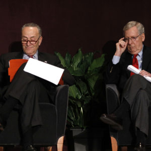 LOUISVILLE, KY - FEBRUARY 12: U.S. Senate Majority Leader Mitch McConnell (right) (R-KY) and U.S. Senate Democratic Leader Chuck Schumer (D-NY) wait on the stage together at the University of Louisville's McConnell Center where Schumer was scheduled to speak February 12, 2018 in Louisville, Kentucky. Sen. Schumer spoke at the event as part of the Center's Distinguished Speaker Series, and Sen. McConnell introduced him. (Photo by Bill Pugliano/Getty Images)