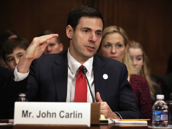 WASHINGTON, DC - JANUARY 08:  Acting Assistant Attorney General for National Security at the Department of Justice John Carlin testifies as his wife Sarah listens during his confirmation hearing before the Senate Judiciary Committee January 8, 2014 on Capitol Hill in Washington, DC. Carlin has been nominated by President Barack Obama to become the next Assistant Attorney General for National Security at the Department of Justice.  (Photo by Alex Wong/Getty Images)