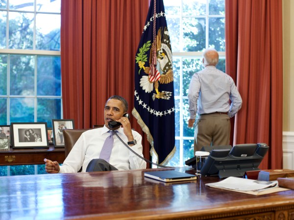 Vice President Joe Biden looks out the window as President Barack Obama talks on the phone with House Speaker John Boehner in the Oval Office to discuss ongoing efforts in the debt limit and deficit reduction talks, Sunday, July 31, 2011. (Official White House Photo by Pete Souza)This official White House photograph is being made available only for publication by news organizations and/or for personal use printing by the subject(s) of the photograph. The photograph may not be manipulated in any way and may not be used in commercial or political materials, advertisements, emails, products, promotions that in any way suggests approval or endorsement of the President, the First Family, or the White House.