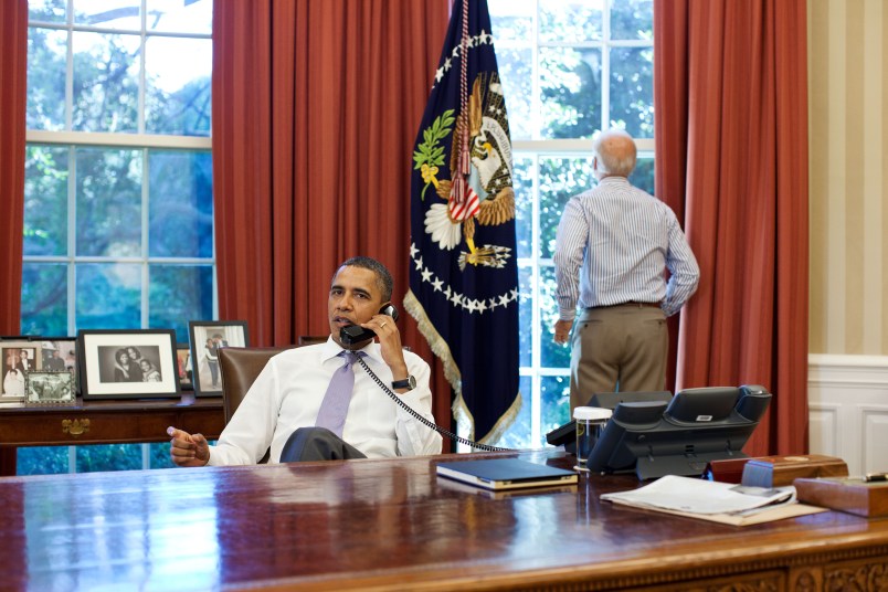 Vice President Joe Biden looks out the window as President Barack Obama talks on the phone with House Speaker John Boehner in the Oval Office to discuss ongoing efforts in the debt limit and deficit reduction talks, Sunday, July 31, 2011. (Official White House Photo by Pete Souza)This official White House photograph is being made available only for publication by news organizations and/or for personal use printing by the subject(s) of the photograph. The photograph may not be manipulated in any way and may not be used in commercial or political materials, advertisements, emails, products, promotions that in any way suggests approval or endorsement of the President, the First Family, or the White House.
