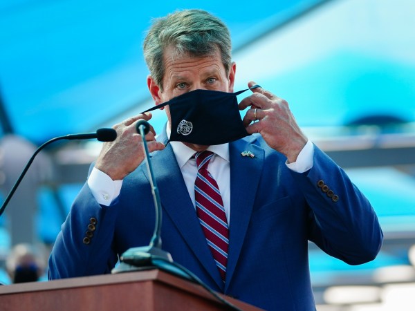 ATLANTA, GA - AUGUST 10: Georgia Governor Brian Kemp puts on a mask after speaking at a press conference announcing statewide expanded COVID testing on August 10, 2020 in Atlanta, Georgia. (Photo by Elijah Nouvelage/Getty Images)