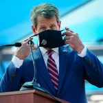 ATLANTA, GA - AUGUST 10: Georgia Governor Brian Kemp puts on a mask after speaking at a press conference announcing statewide expanded COVID testing on August 10, 2020 in Atlanta, Georgia. (Photo by Elijah Nouvelage/Getty Images)