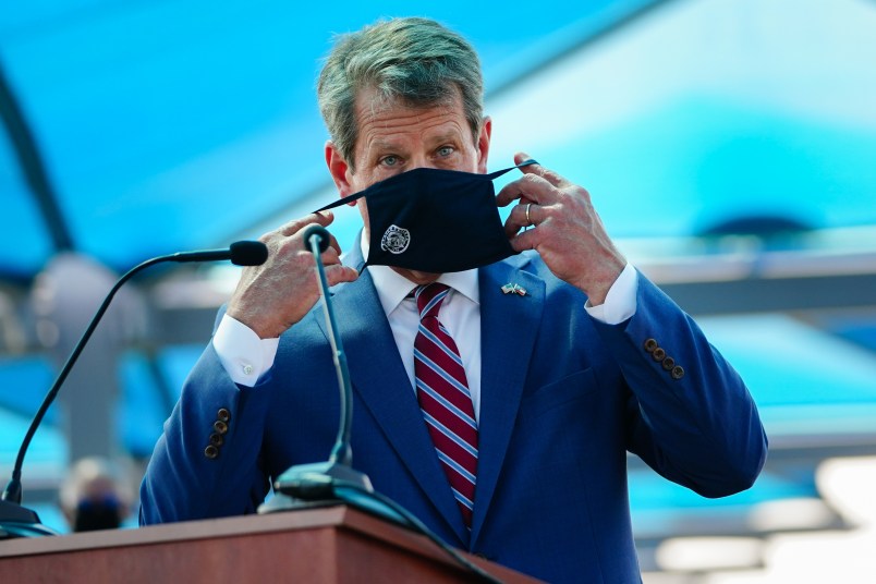 ATLANTA, GA - AUGUST 10: Georgia Governor Brian Kemp puts on a mask after speaking at a press conference announcing statewide expanded COVID testing on August 10, 2020 in Atlanta, Georgia. (Photo by Elijah Nouvelage/Getty Images)