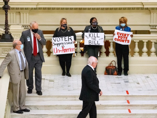ATLANTA, GA - MARCH 08: Demonstrators hold a “sit in” inside of the Capitol building in opposition of House Bill 531 on March 8, 2021 in Atlanta, Georgia. HB531 will restrict early voting hours, remove drop boxes, and require the use of a government ID when voting by mail.  (Photo by Megan Varner/Getty Images)