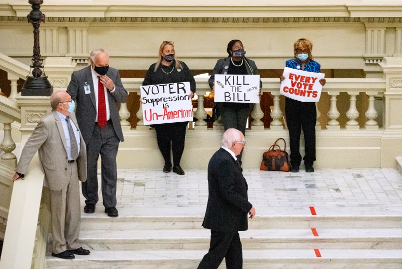 ATLANTA, GA - MARCH 08: Demonstrators hold a “sit in” inside of the Capitol building in opposition of House Bill 531 on March 8, 2021 in Atlanta, Georgia. HB531 will restrict early voting hours, remove drop boxes, and require the use of a government ID when voting by mail.  (Photo by Megan Varner/Getty Images)